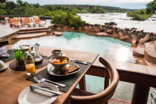 Lemala Wild Waters Lodge sits in a big rainforest on its own island, looking out over the strong Nile River in Jinja in eastern Uganda